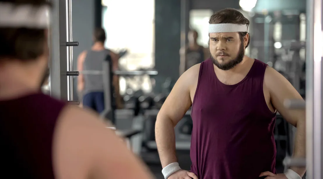 man working out in gym to lose belly fat